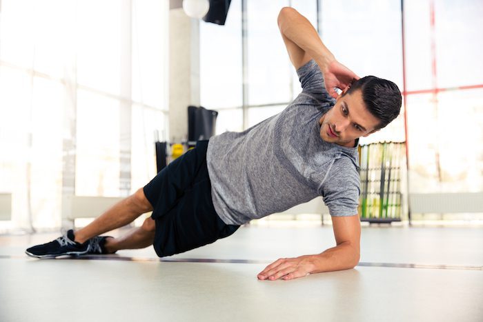 Man Doing Side Plank At Gym