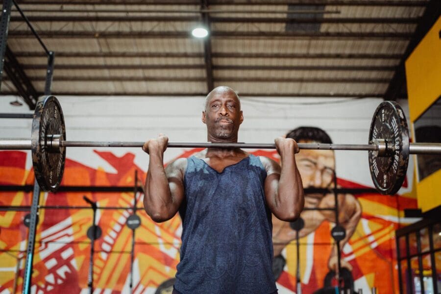 strength and conditioning coach jobs man with barbell