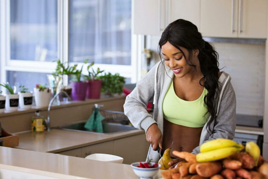gut health supplements vegetables chopping in kitchen