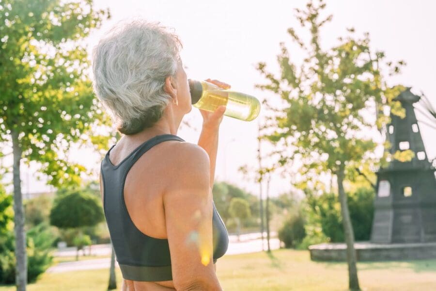 An elderly athlete hydrating