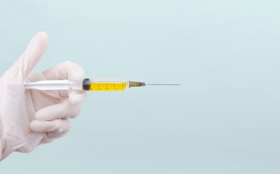 Medical professional administering GLP 1 whilst telling patient how to prevent muscle loss on Ozempic.