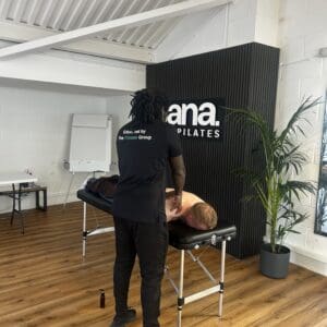 sports massage course instructor demonstrating to students.