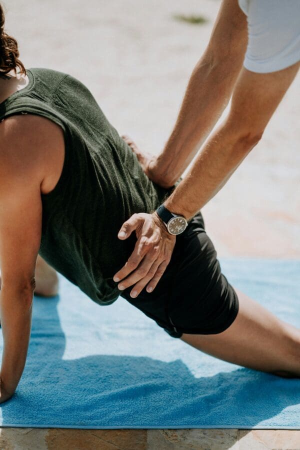 PT showing a client how to do lower back pain exercises.