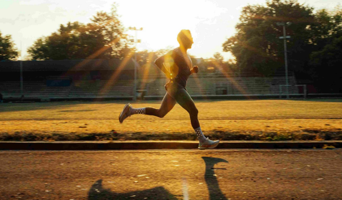 Runner training outdoors in warm sunlight